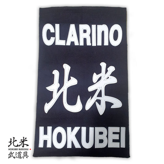 Clarino Kendo Zekken nafuda name tag made from synthetic leather with bold stitching, customizable with dojo and name.